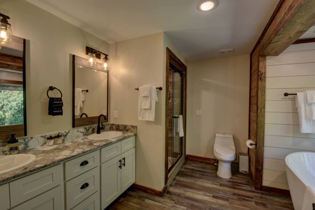 Main level Master has double vanity, separate shower, along with all you need for your stay with provided hand soap, QTips, makeup pads, body wash, shampoo, conditioner, and luxury towels