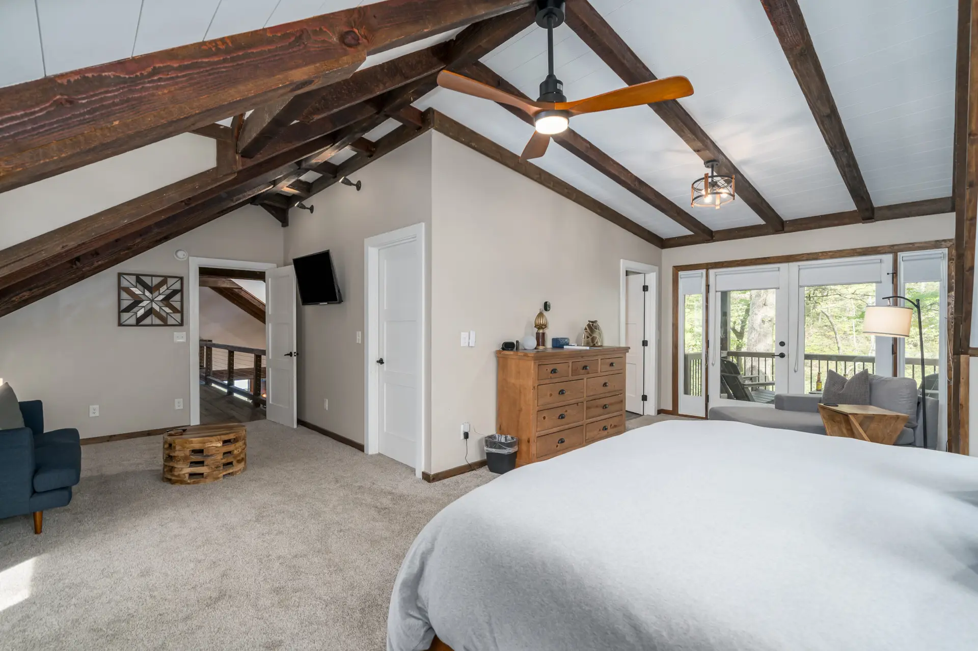 Back across the catwalk you find our upper level master bedroom with a king bed, loveseat, TV, and more
