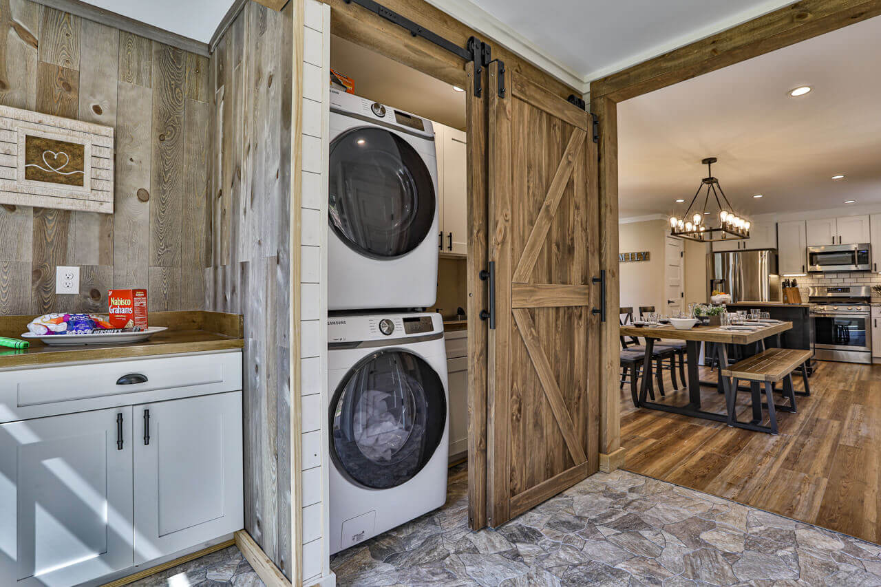 Mudroom offers laundry, utility sink, and work space