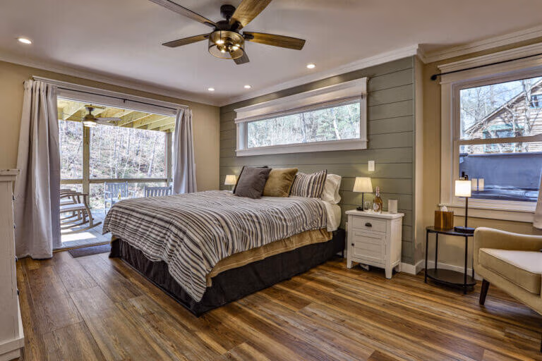 First-floor master suite at The Farmhouse cabin in Ellijay, GA with large windows and cozy deco